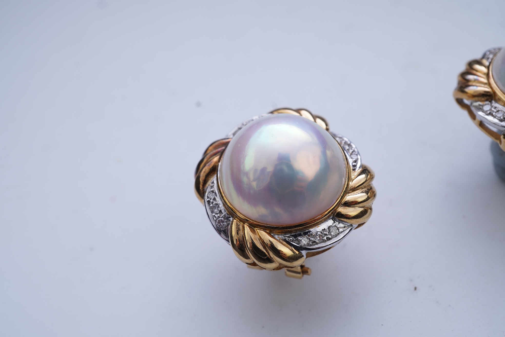 A pair of mabé cultured pearl and diamond earrings